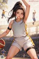 A girl in a basketball uniform holding a basketball.