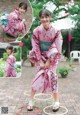 A woman in a pink kimono sitting on a hula hoop.